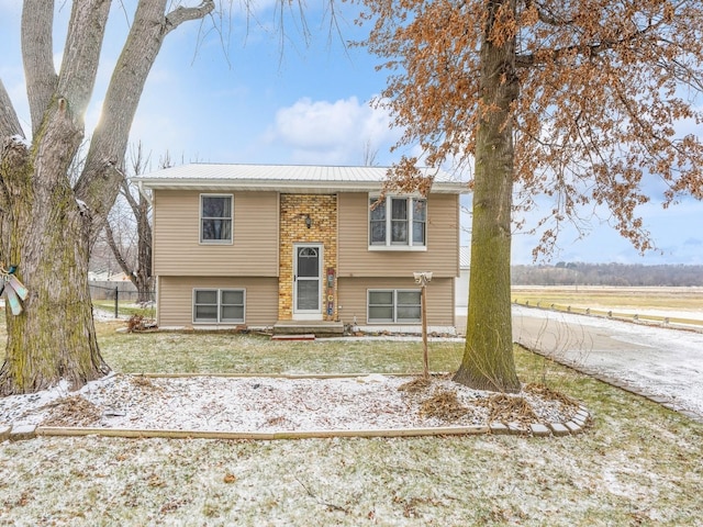 raised ranch with a front lawn