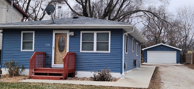 view of front of property with a garage and an outdoor structure