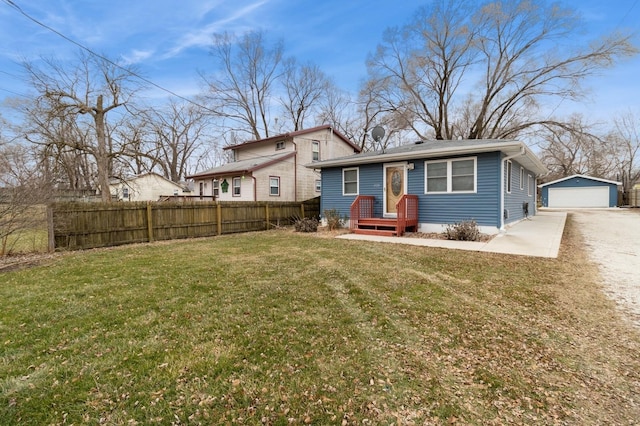 view of front of property with an outbuilding, a front yard, and a garage