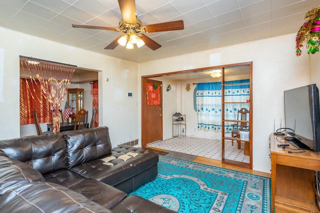 living room with hardwood / wood-style flooring and ceiling fan