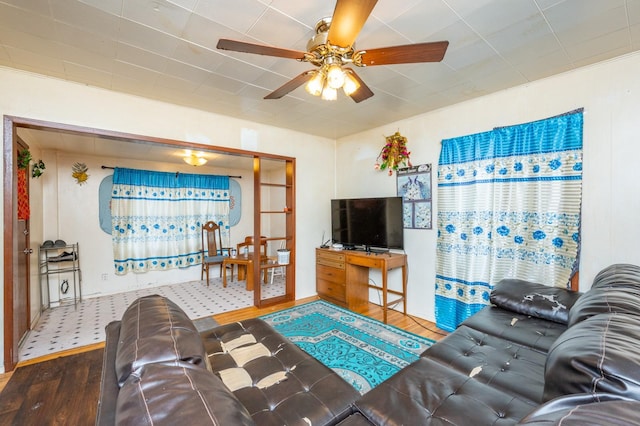 living room featuring hardwood / wood-style floors and ceiling fan