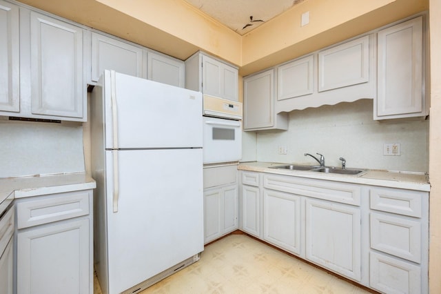 kitchen featuring white cabinets, white appliances, sink, and a textured ceiling