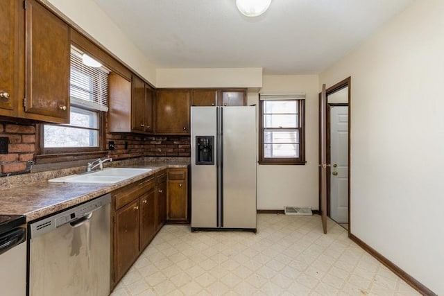 kitchen featuring plenty of natural light, sink, and stainless steel appliances