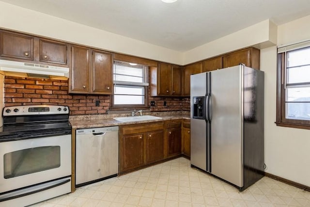 kitchen featuring plenty of natural light, decorative backsplash, sink, and appliances with stainless steel finishes