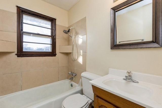 full bathroom featuring vanity, toilet, and tiled shower / bath combo