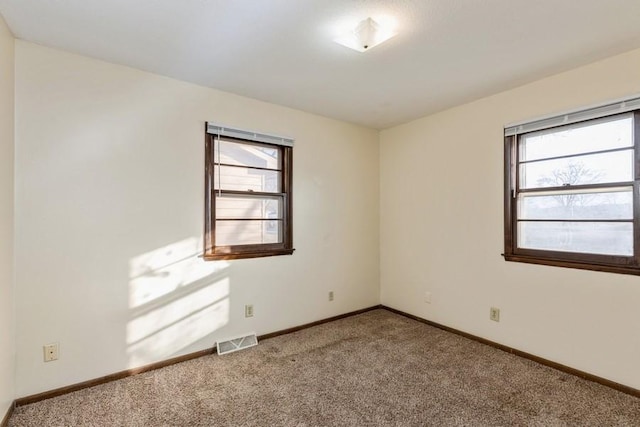 empty room with carpet flooring and plenty of natural light