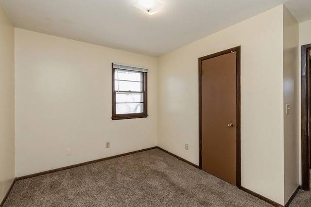 unfurnished room featuring carpet flooring