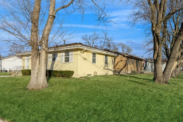 view of side of home featuring a lawn