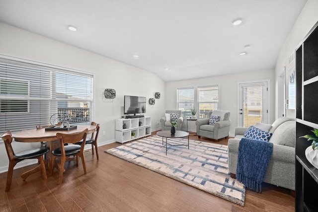 living room featuring hardwood / wood-style flooring and lofted ceiling