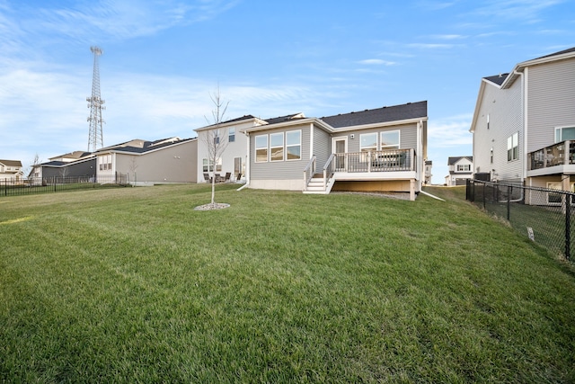 back of house featuring a yard and a wooden deck