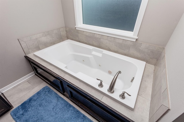 bathroom with a jetted tub, tile patterned flooring, and baseboards