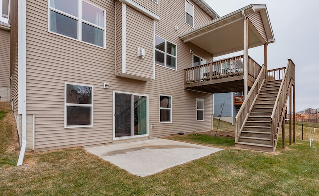 rear view of property featuring a patio, a lawn, stairway, fence, and a wooden deck