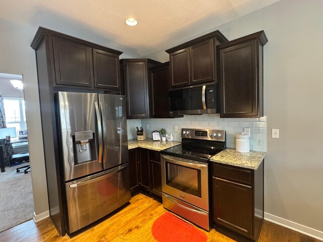 bathroom with wood finished floors and baseboards