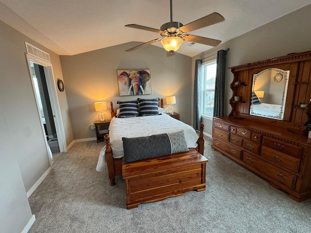 carpeted bedroom featuring a ceiling fan, lofted ceiling, visible vents, and baseboards