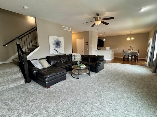 living room featuring baseboards, visible vents, stairway, and carpet flooring