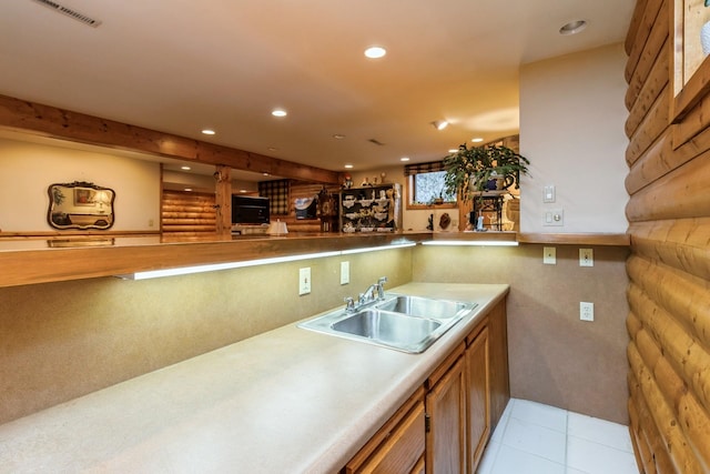 kitchen with sink and light tile patterned flooring