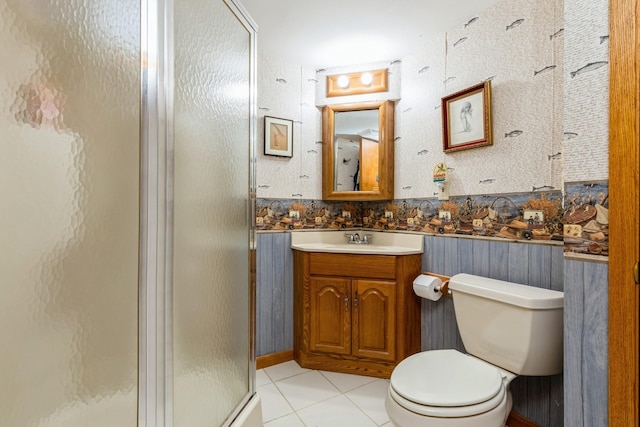 bathroom with an enclosed shower, vanity, tile patterned floors, and toilet