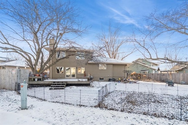 snow covered property featuring a deck