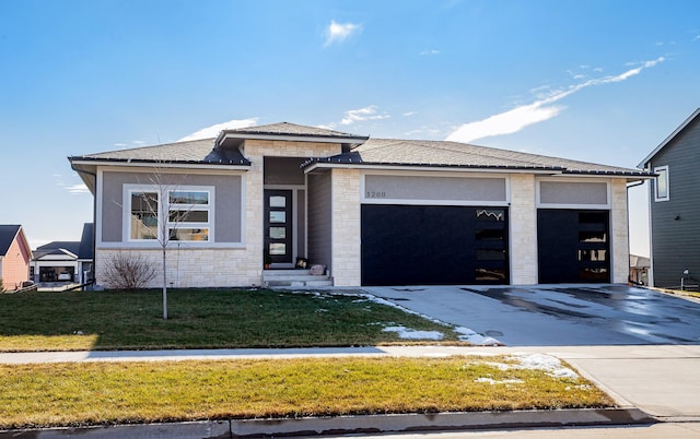 prairie-style house featuring a front yard and a garage