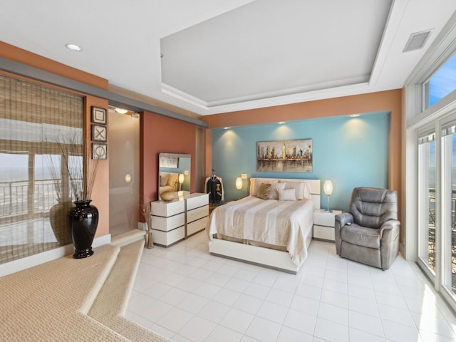 bedroom featuring a raised ceiling, light tile patterned floors, and access to outside