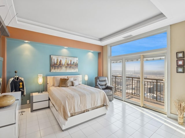 tiled bedroom featuring access to exterior and a tray ceiling