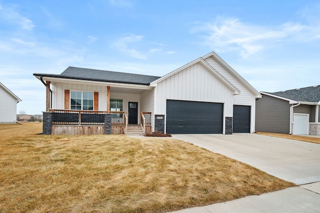 view of front facade with a garage, covered porch, and a front lawn