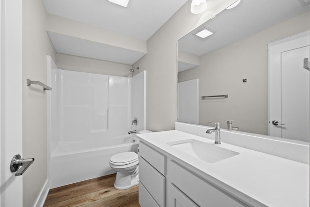 bathroom with vanity, bathing tub / shower combination, wood finished floors, and toilet