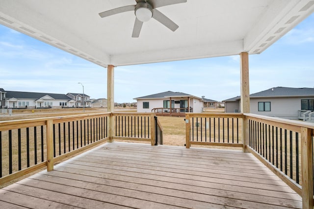 deck featuring a residential view and a ceiling fan