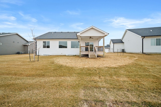 rear view of property with a ceiling fan, central AC, a lawn, and a wooden deck