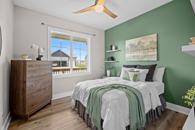 bedroom featuring baseboards, ceiling fan, and hardwood / wood-style floors