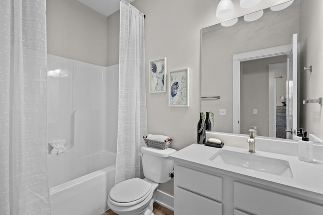 bathroom with vanity, shower / bath combo, and toilet