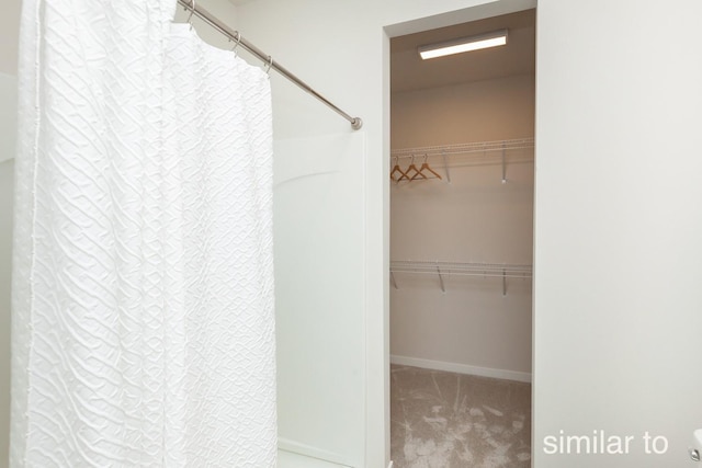 spacious closet featuring carpet floors