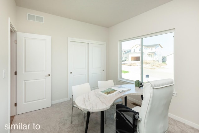 office space featuring visible vents, light colored carpet, and baseboards