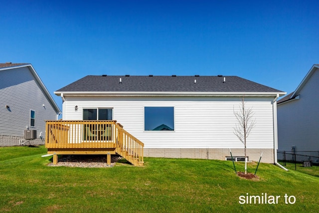 rear view of property with a deck, cooling unit, a yard, and roof with shingles