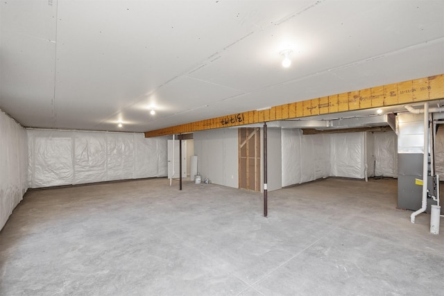 unfinished below grade area featuring heating unit