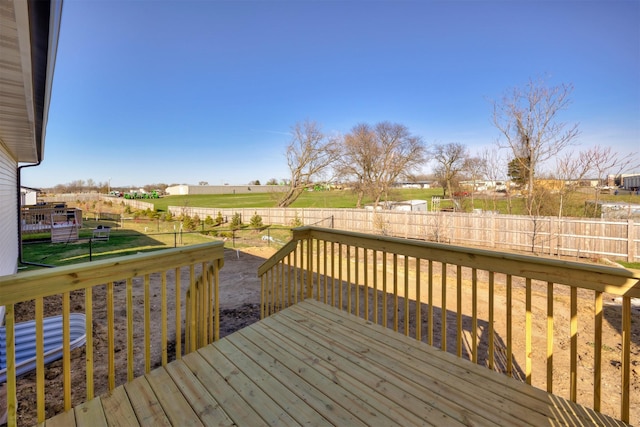 deck with a fenced backyard and a yard
