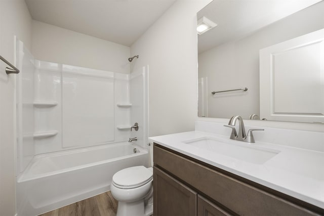 full bathroom featuring toilet, vanity, wood finished floors, and tub / shower combination