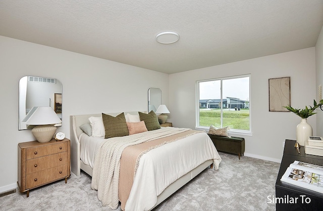 carpeted bedroom with a textured ceiling