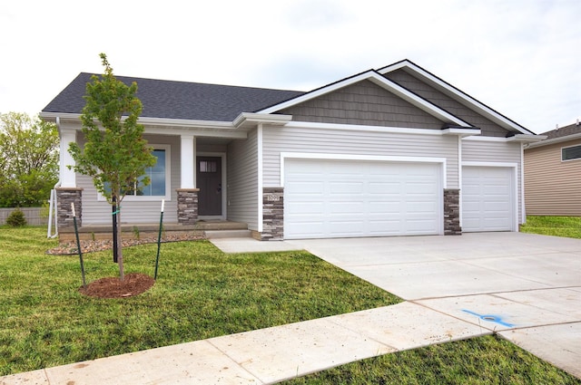 1099 NE 64th Ave, Des Moines, IA 50313 - craftsman-style home with stone siding, a garage, concrete driveway, and a front lawn