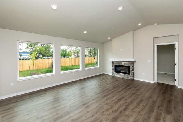 1099 NE 64th Ave, Des Moines, IA 50313 - unfurnished living room with vaulted ceiling, healthy amount of natural light, a fireplace, dark wood finished floors, and recessed lighting
