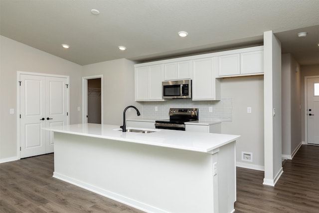 1099 NE 64th Ave, Des Moines, IA 50313 - kitchen with range with electric cooktop, stainless steel microwave, a sink, decorative backsplash, and white cabinetry