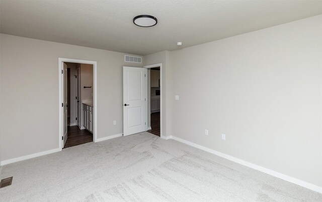 1099 NE 64th Ave, Des Moines, IA 50313 - unfurnished bedroom featuring carpet, baseboards, and connected bathroom