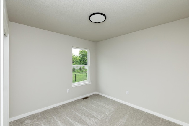 1099 NE 64th Ave, Des Moines, IA 50313 - spare room featuring baseboards and light colored carpet
