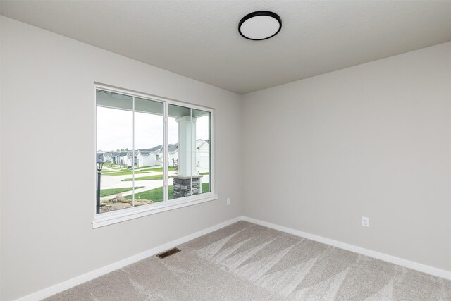 1099 NE 64th Ave, Des Moines, IA 50313 - spare room featuring carpet flooring and baseboards