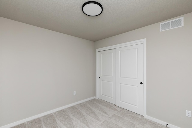 1099 NE 64th Ave, Des Moines, IA 50313 - unfurnished bedroom featuring light colored carpet, baseboards, and a closet