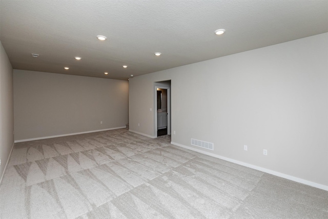 1099 NE 64th Ave, Des Moines, IA 50313 - unfurnished room with light colored carpet, recessed lighting, and baseboards