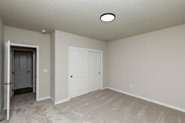 1099 NE 64th Ave, Des Moines, IA 50313 - unfurnished bedroom featuring light colored carpet, a closet, and baseboards