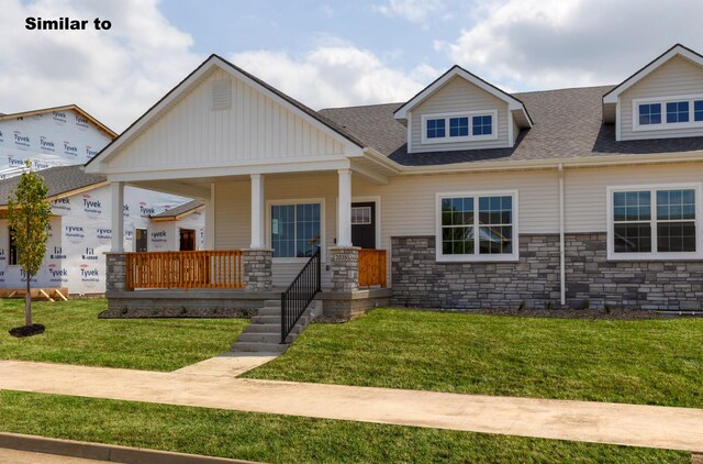 view of front facade with covered porch and a front yard