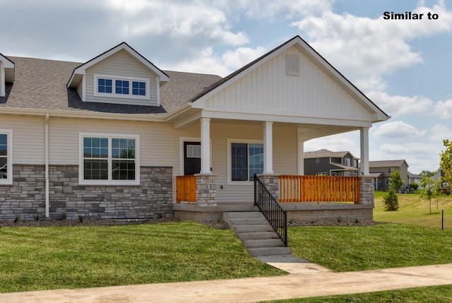 view of front of property with stone siding, a front lawn, a porch, and a shingled roof