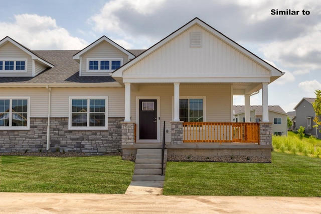 craftsman-style home with a porch, a front lawn, and a shingled roof